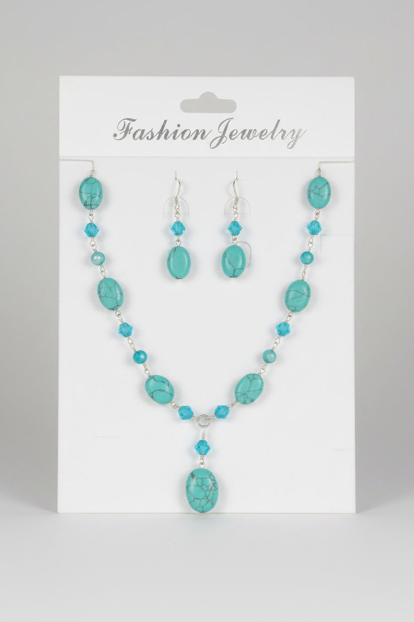 A turquoise and blue bead necklace and earring set displayed on a black mannequin bust, with the necklace labeled 'FASHION JEWELRY'.